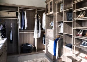 a custom closet featuring women's and men's clothing, shoes, and accessories